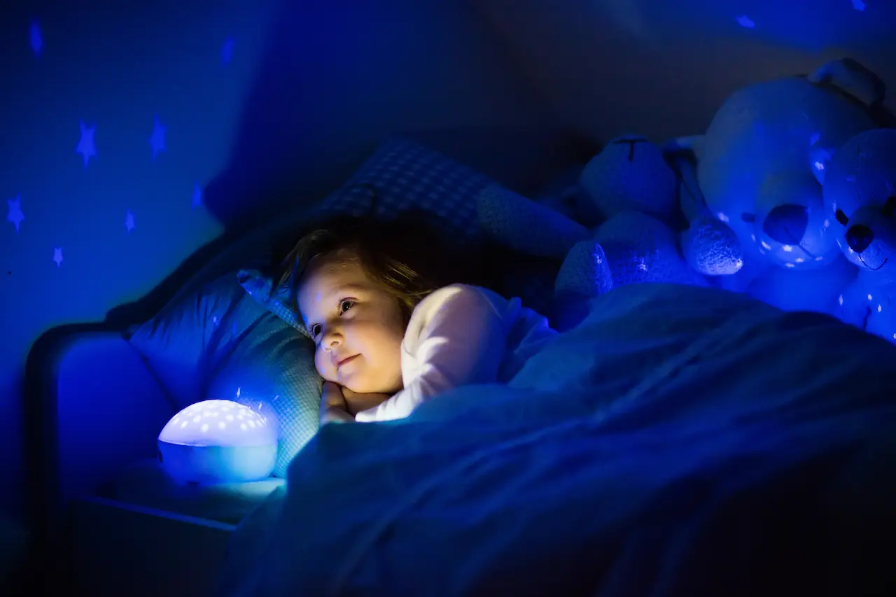 Little Girl in Bed with Night Lamp