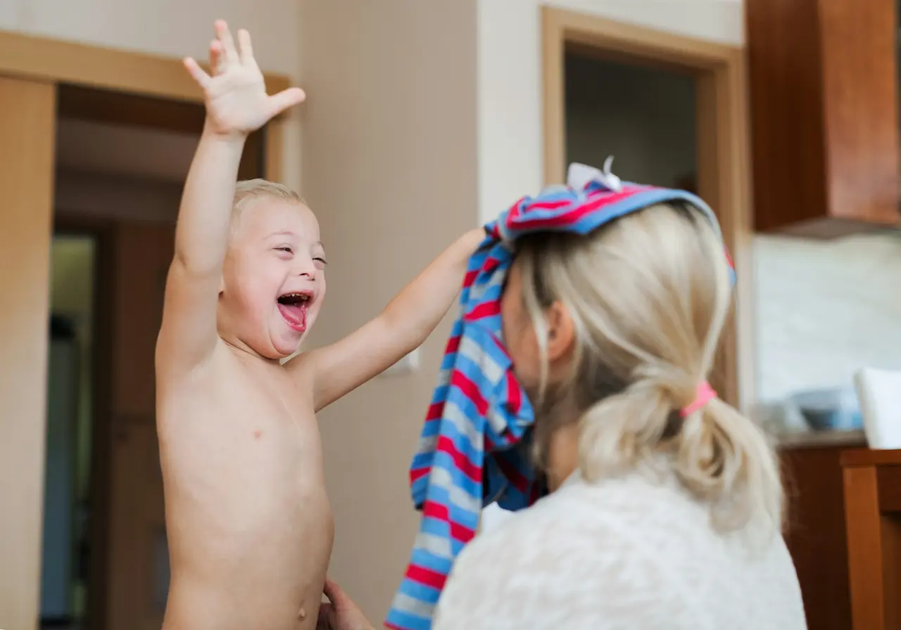 Little Boy Throwing Shirt to His Mom Face
